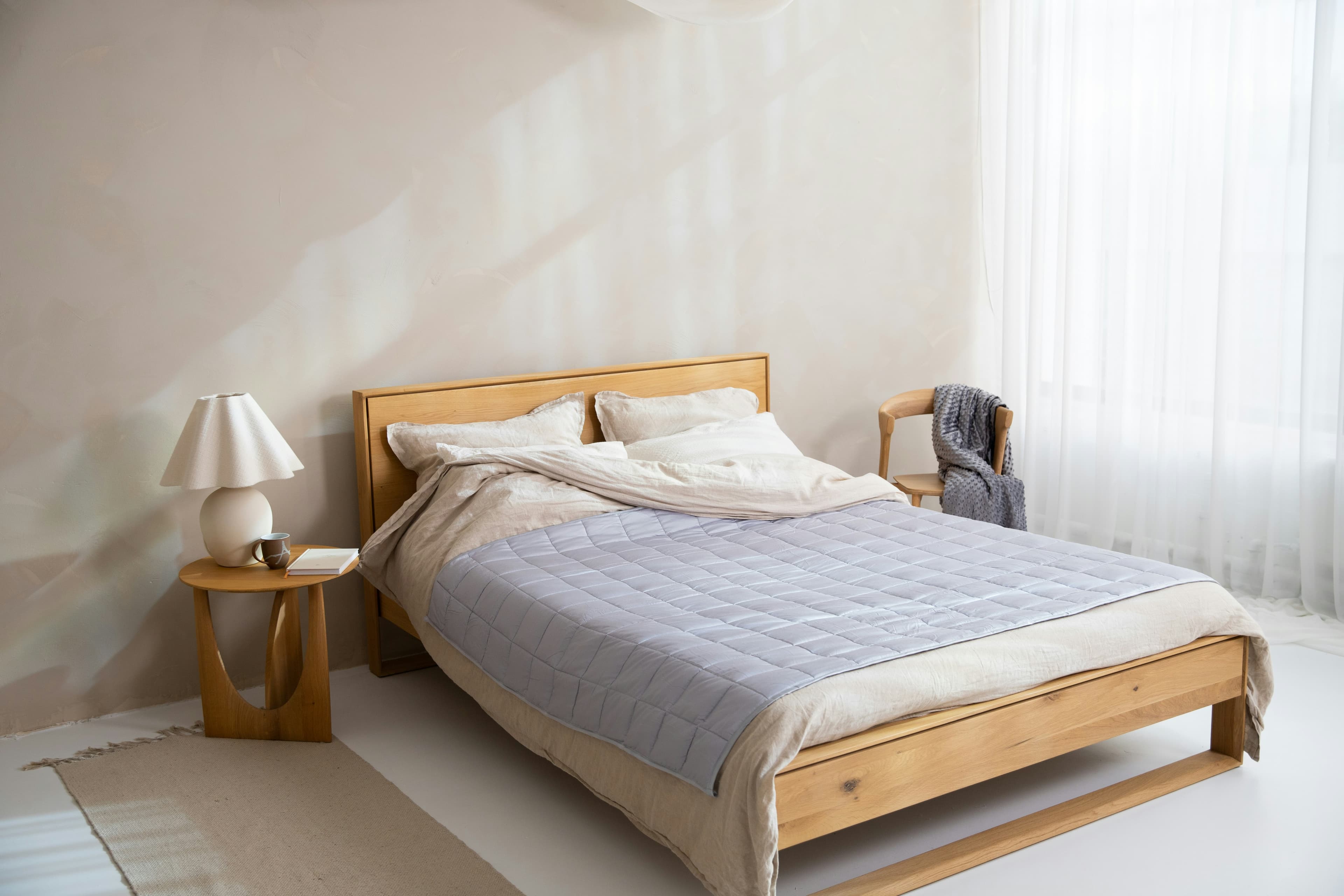 Bright minimalist bedroom with a fresh, clean bed ready after mattress cleaning